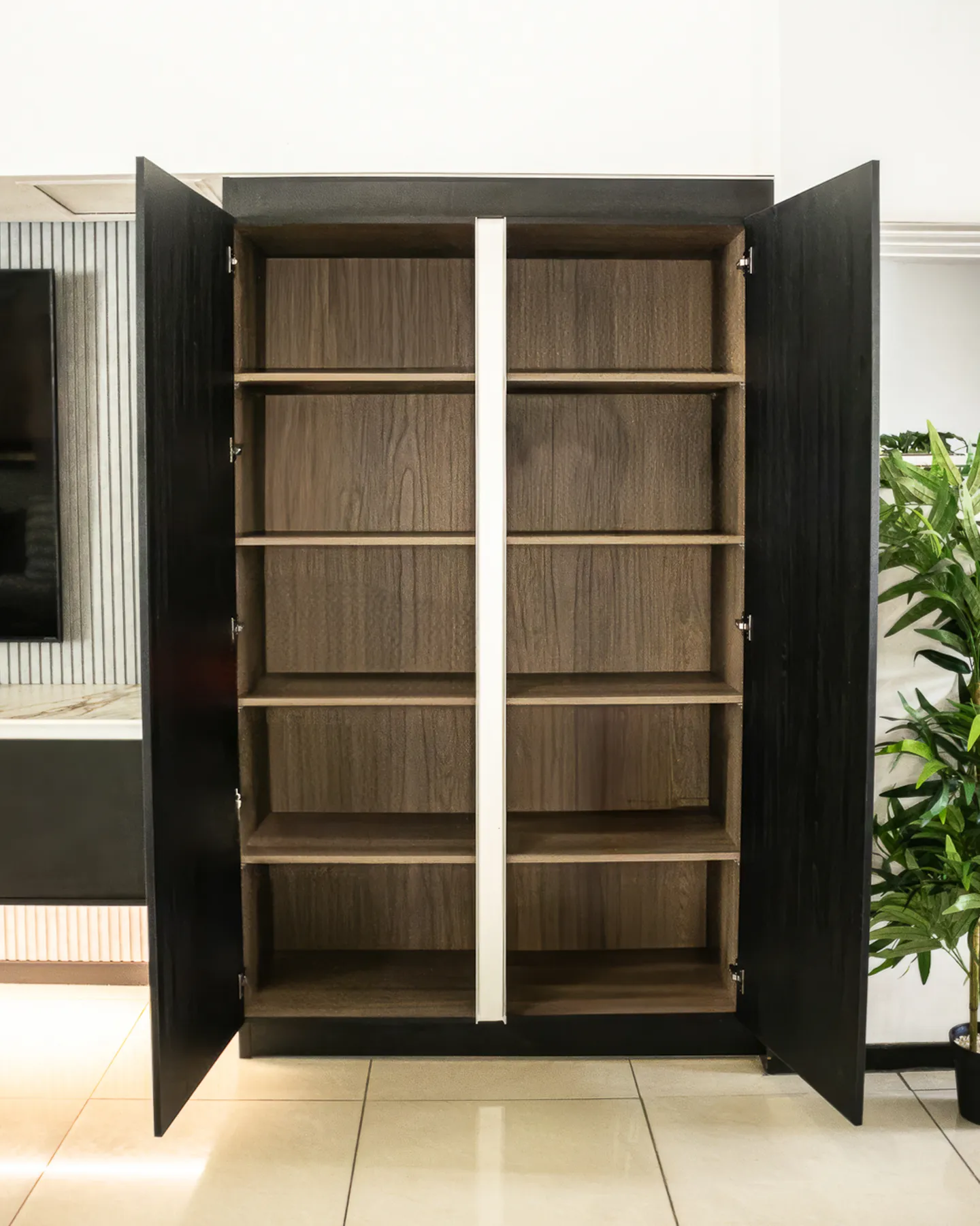 Tall black cabinet opened to show timber shelving